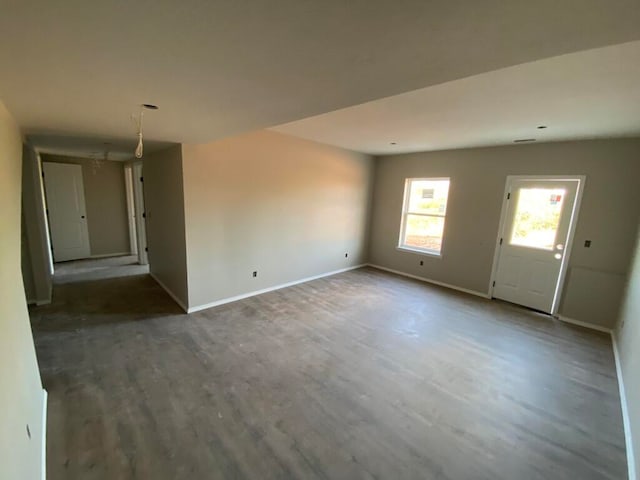 spare room featuring dark wood-type flooring