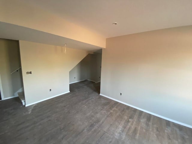 empty room with dark hardwood / wood-style flooring