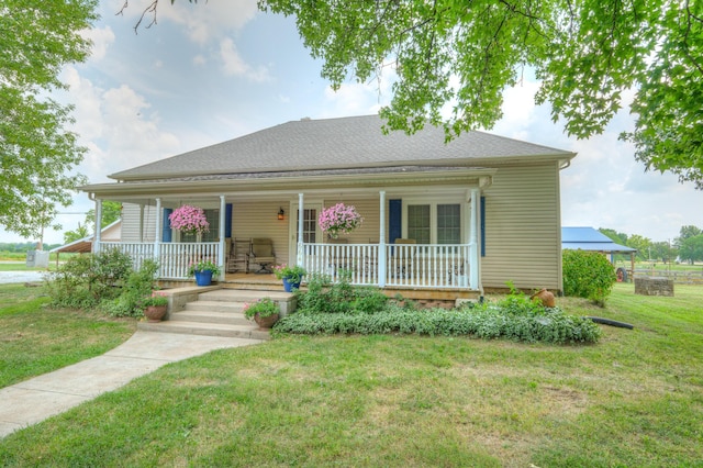 view of front of property with a porch and a front lawn