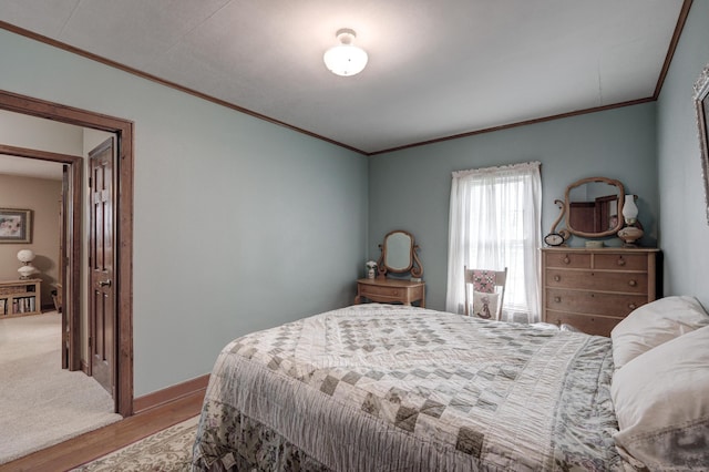 bedroom featuring light wood-type flooring and crown molding