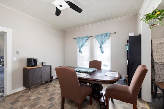 dining area with ceiling fan and crown molding