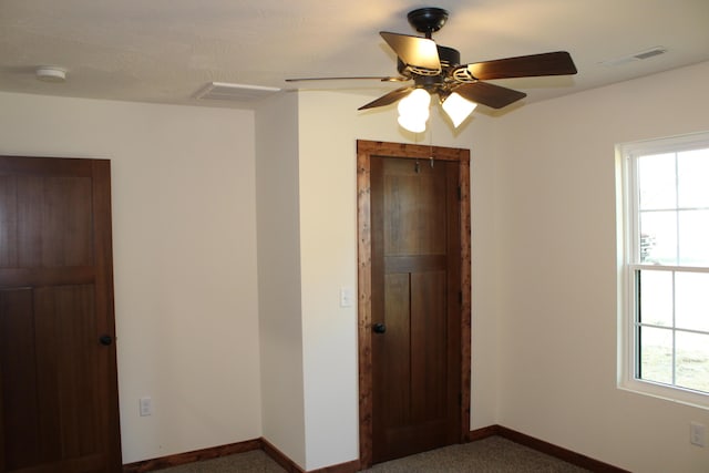 410 Park St, Taneyville, MO 65759 - unfurnished bedroom featuring multiple windows, baseboards, carpet flooring, and a closet