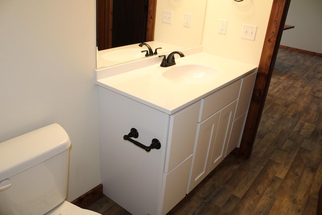 410 Park St, Taneyville, MO 65759 - half bath featuring vanity, wood finished floors, toilet, and baseboards