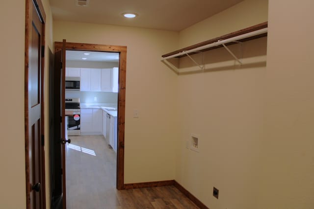 410 Park St, Taneyville, MO 65759 - laundry room with dark wood-style flooring, hookup for an electric dryer, hookup for a washing machine, recessed lighting, and baseboards
