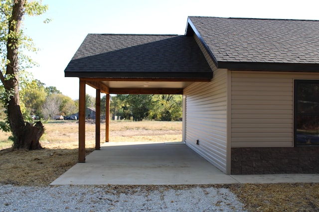 430 Park St, Taneyville, MO 65759 - view of side of property featuring a shingled roof and a patio area