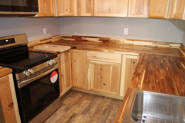 430 Park St, Taneyville, MO 65759 - kitchen with stainless steel appliances, butcher block countertops, light brown cabinetry, and wood finished floors