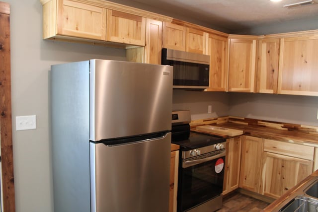 430 Park St, Taneyville, MO 65759 - kitchen with stainless steel appliances, light brown cabinets, wood counters, and dark wood-style floors