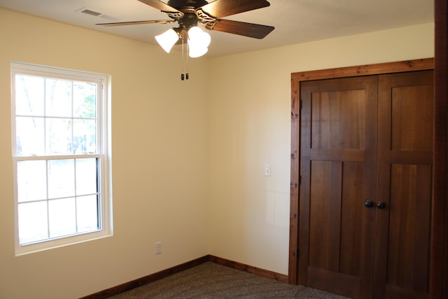430 Park St, Taneyville, MO 65759 - spare room with dark carpet, baseboards, and a ceiling fan