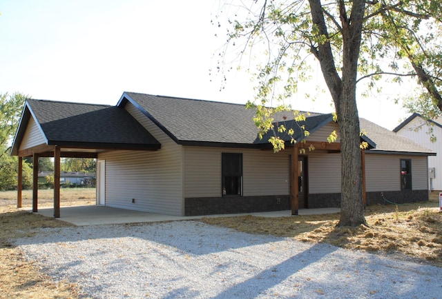 430 Park St, Taneyville, MO 65759 - ranch-style house with roof with shingles, an attached carport, and driveway