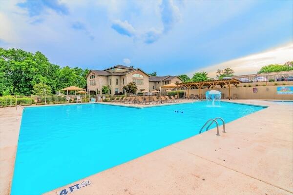 view of swimming pool with a patio and pool water feature