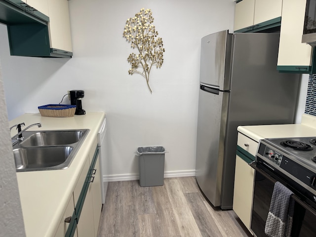 kitchen with light hardwood / wood-style floors, sink, white stove, and white cabinetry