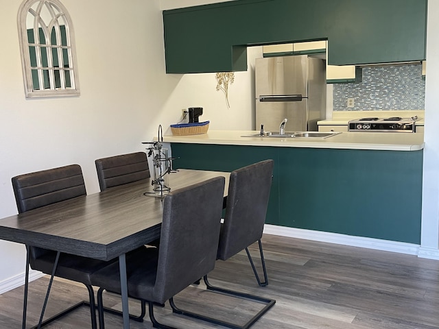 dining area with sink and dark hardwood / wood-style flooring