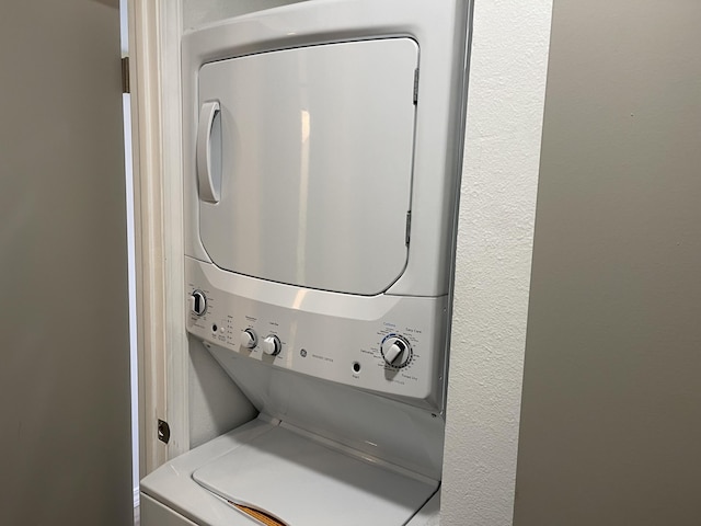 laundry area featuring stacked washer and clothes dryer