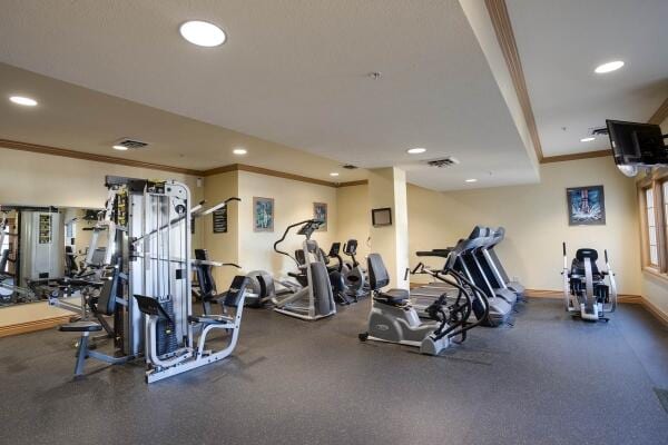 exercise room featuring ornamental molding