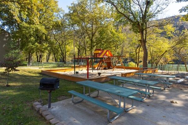 view of property's community featuring a playground and a lawn