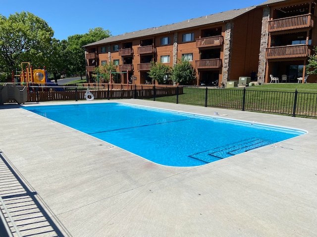 view of pool featuring a playground