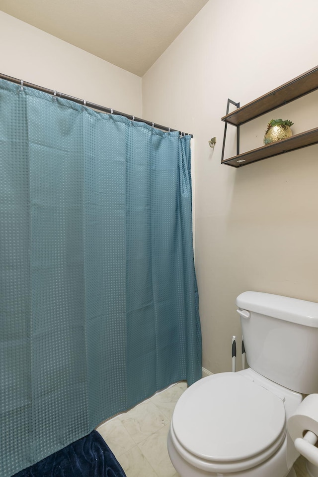 bathroom featuring walk in shower and toilet