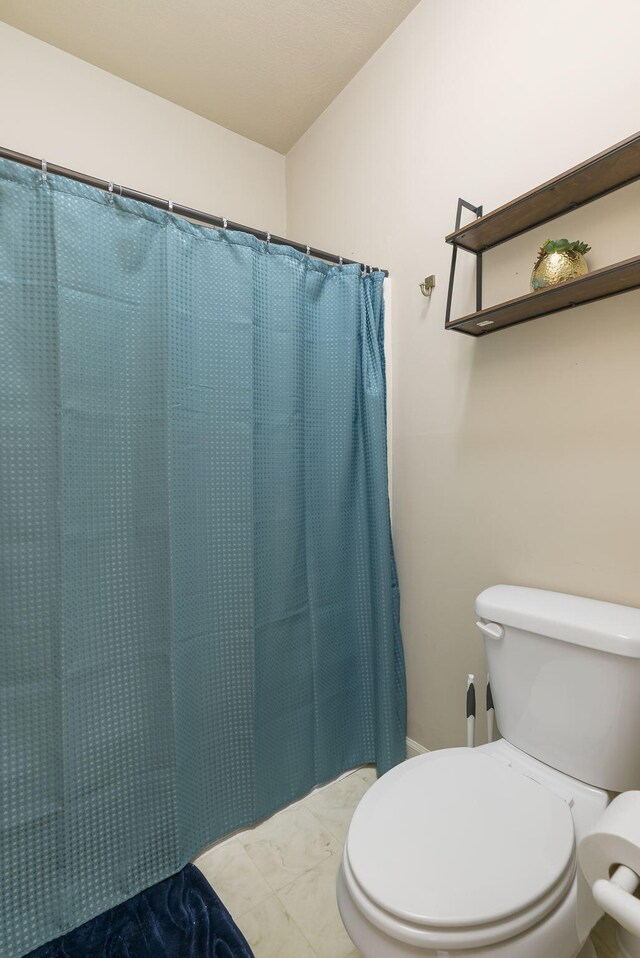 835 Fairview Unit 4, Branson, MO 65616 - full bathroom featuring a shower with curtain, marble finish floor, and toilet