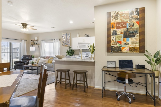 interior space featuring wood-type flooring and ceiling fan