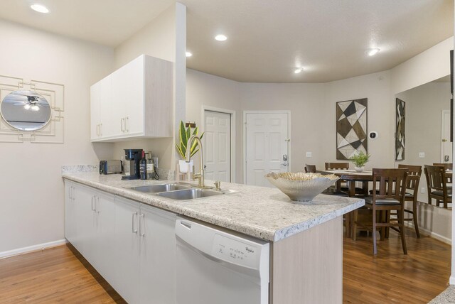 835 Fairview Unit 4, Branson, MO 65616 - kitchen with a peninsula, a sink, baseboards, white dishwasher, and light countertops