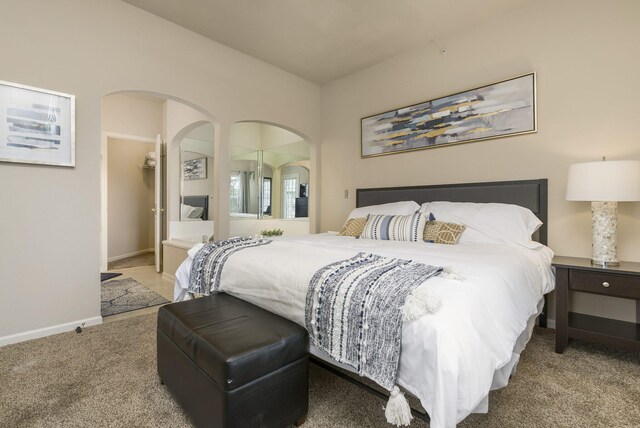 835 Fairview Unit 4, Branson, MO 65616 - bedroom featuring a spacious closet, arched walkways, baseboards, and carpet floors