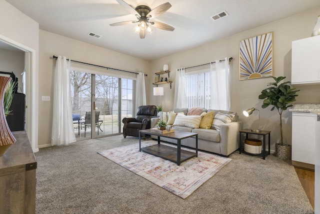 living room featuring light colored carpet and ceiling fan