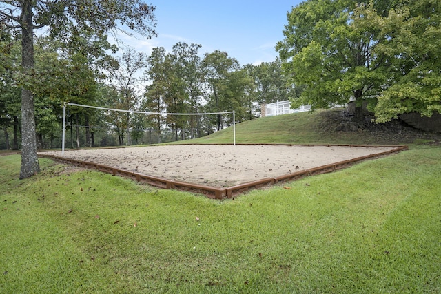 surrounding community with a yard and volleyball court