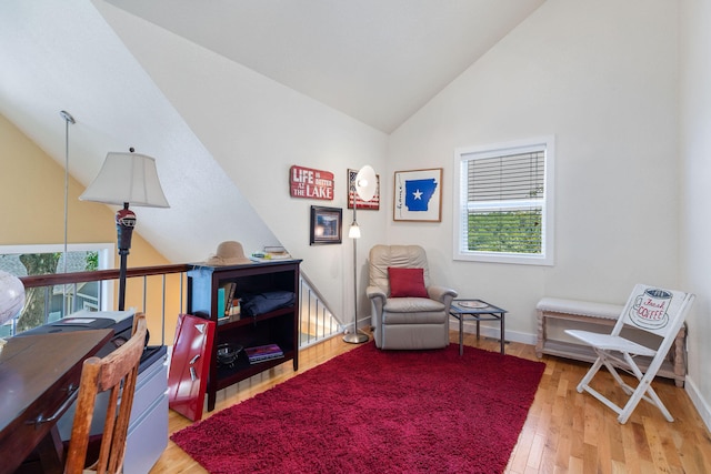 living area with hardwood / wood-style flooring and lofted ceiling