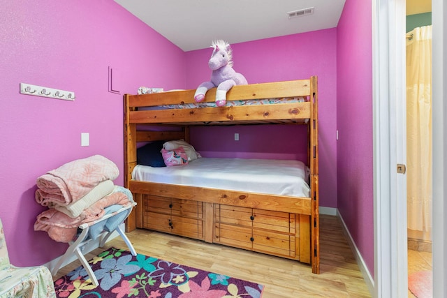 89 Turkey Trl, Blue Eye, MO 65611 - bedroom with baseboards, wood finished floors, and visible vents