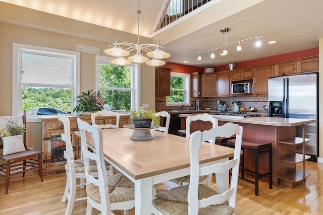 89 Turkey Trl, Blue Eye, MO 65611 - dining space featuring light wood-type flooring and an inviting chandelier