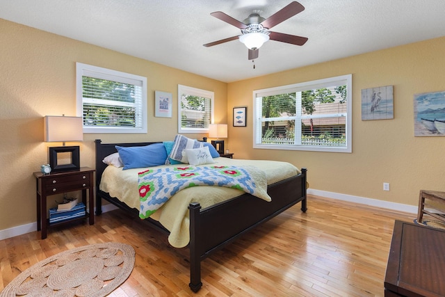 89 Turkey Trl, Blue Eye, MO 65611 - bedroom featuring baseboards, light wood-style floors, and multiple windows