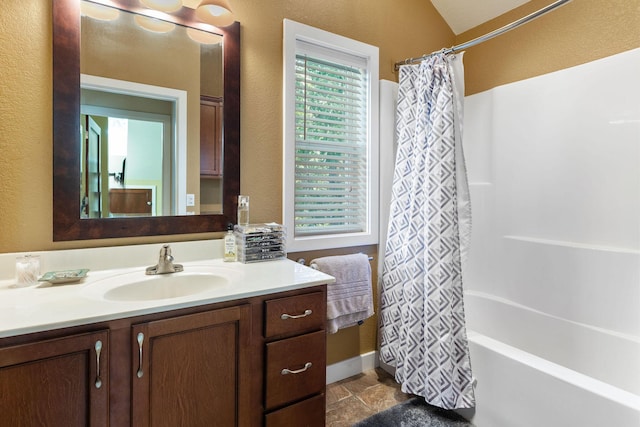 89 Turkey Trl, Blue Eye, MO 65611 - bathroom featuring stone finish floor, a textured wall, vanity, and shower / bath combination with curtain