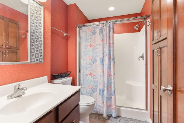 bathroom featuring tile patterned floors, a shower with shower curtain, vanity, and toilet