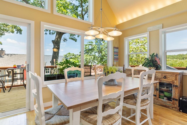 89 Turkey Trl, Blue Eye, MO 65611 - dining space featuring light wood-style floors, a healthy amount of sunlight, and a notable chandelier