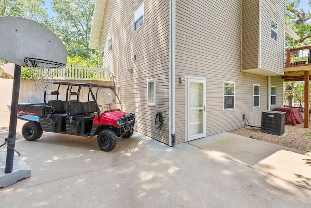 view of side of home featuring central air condition unit and a patio area