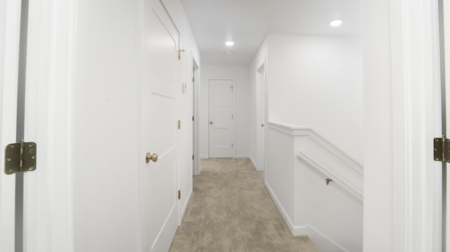 hallway featuring light carpet