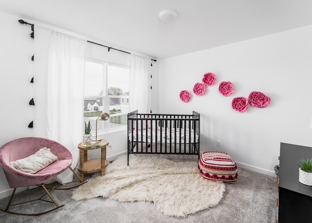 bedroom with a crib and carpet floors