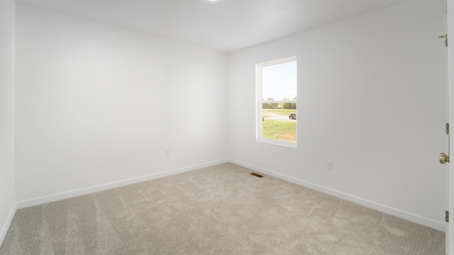 unfurnished room with light carpet