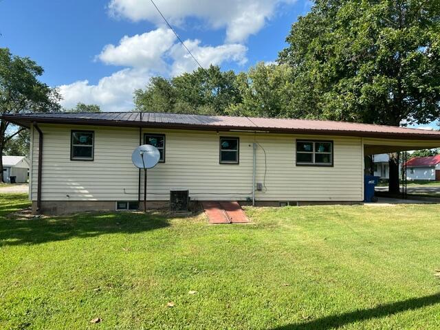 106 Martin St, Licking, MO 65542 - rear view of property featuring a lawn and metal roof