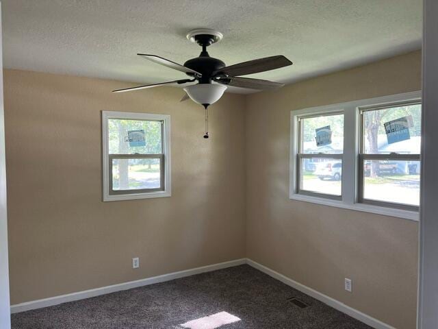 106 Martin St, Licking, MO 65542 - unfurnished room with plenty of natural light, a ceiling fan, baseboards, and dark carpet