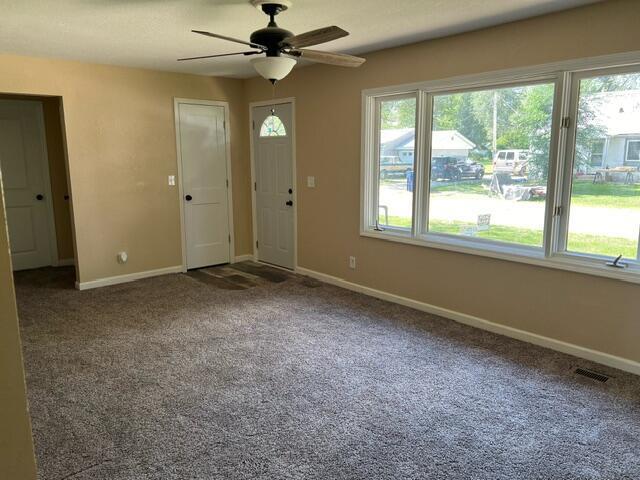106 Martin St, Licking, MO 65542 - foyer featuring carpet, visible vents, baseboards, and ceiling fan