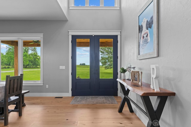 entryway with light wood-type flooring and french doors