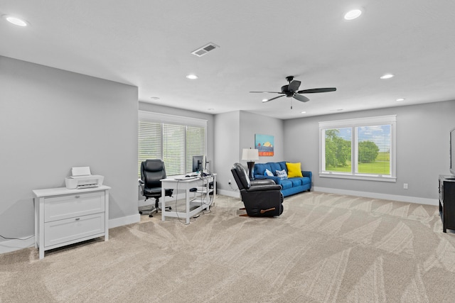 living area featuring ceiling fan and light colored carpet