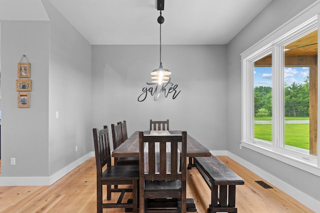 dining space with plenty of natural light and light wood-type flooring