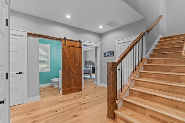 entrance foyer featuring a barn door and light hardwood / wood-style floors