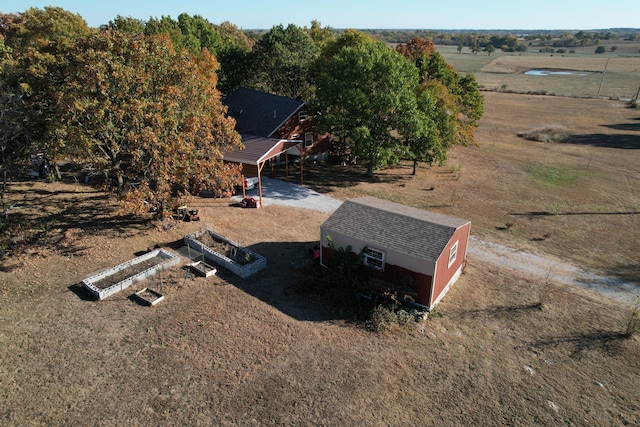 birds eye view of property with a rural view