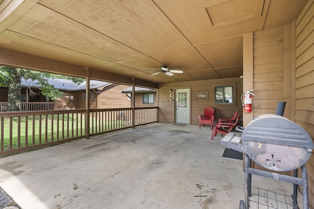 view of patio with fence, a ceiling fan, and area for grilling