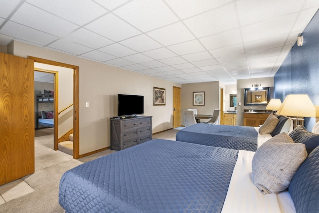 carpeted bedroom with a drop ceiling