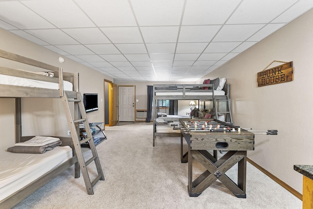 game room with a paneled ceiling, baseboards, and light carpet