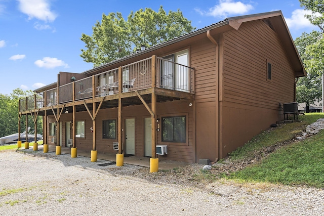 rear view of property with a wooden deck
